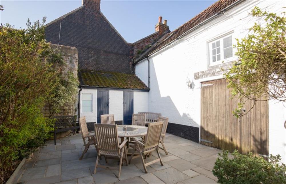 Enclosed courtyard garden with seating for six at The Cabin, Wells-next-the-Sea