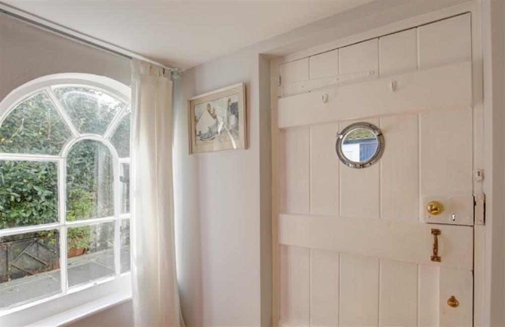 Ground floor: Porthole window door leading from dining room into the courtyard at The Cabin, Wells-next-the-Sea