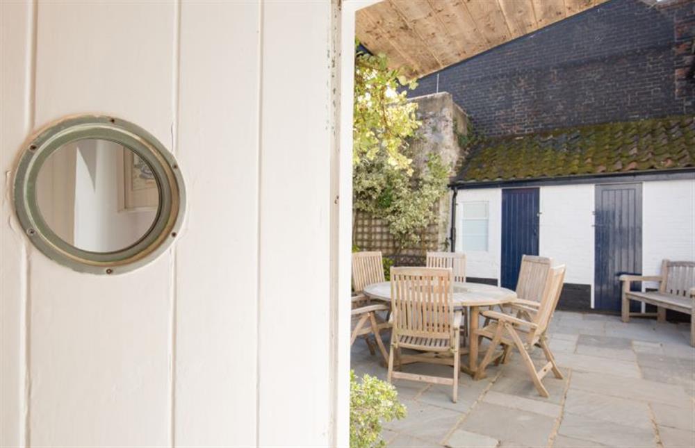 Ground floor: Porthole window door leading to the courtyard  at The Cabin, Wells-next-the-Sea