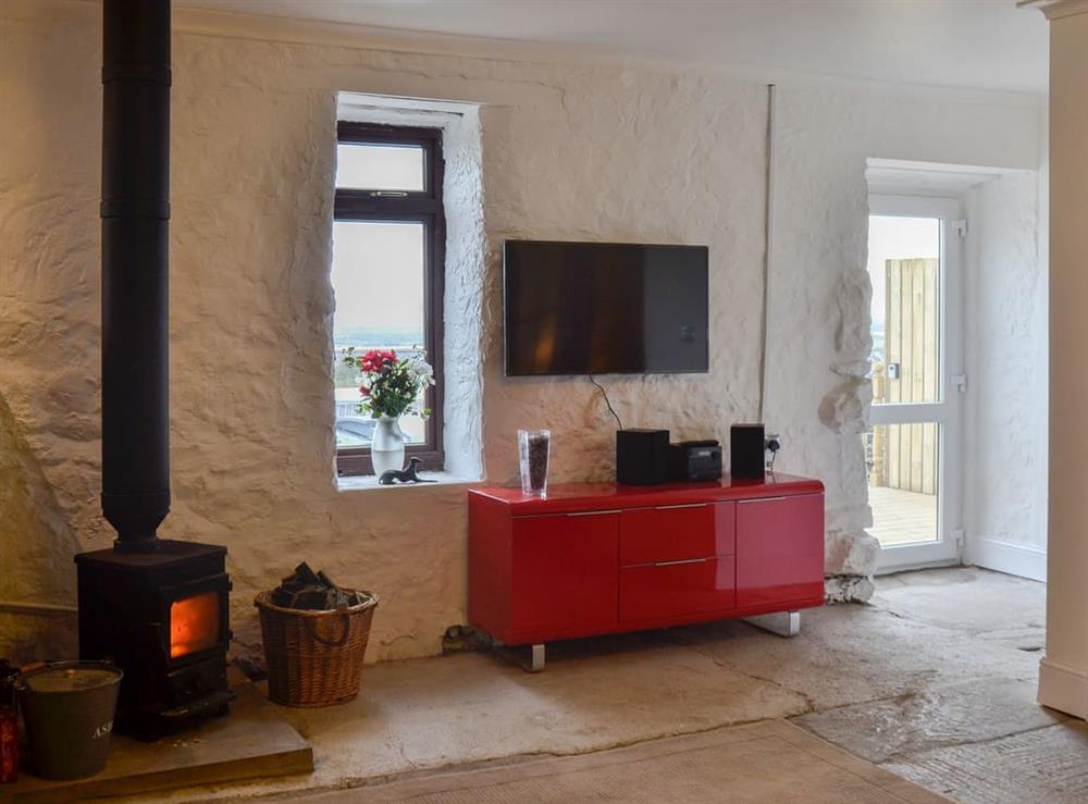 Contemporary kitchen area with traditional wood burner at The Calving Shed in Near Neilston, Lanarkshire