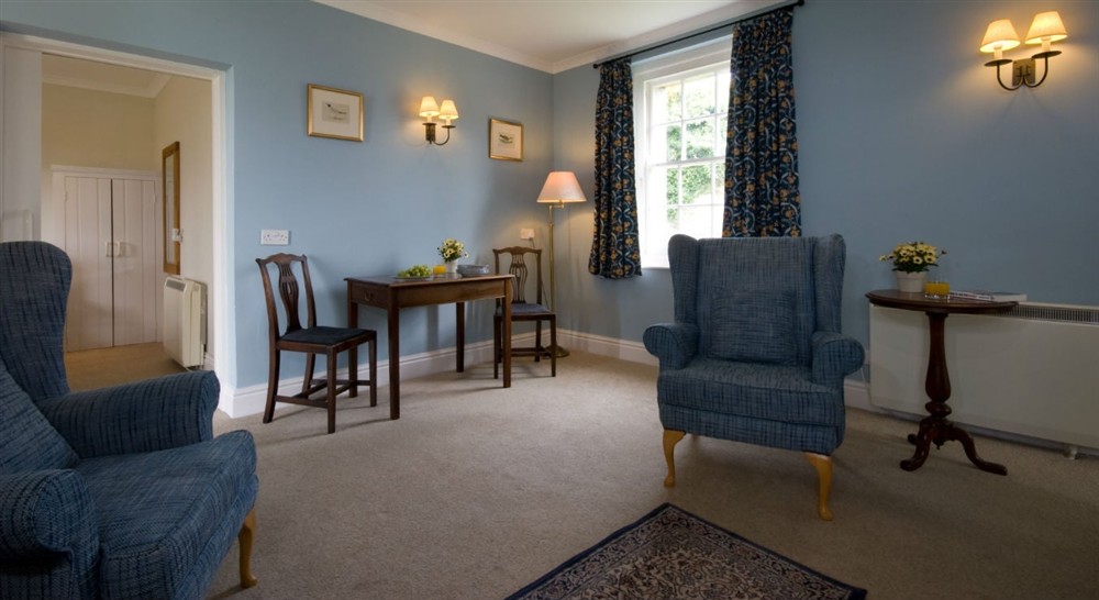 The sitting and dining room at The Captain's Quarter in Roseland, Cornwall