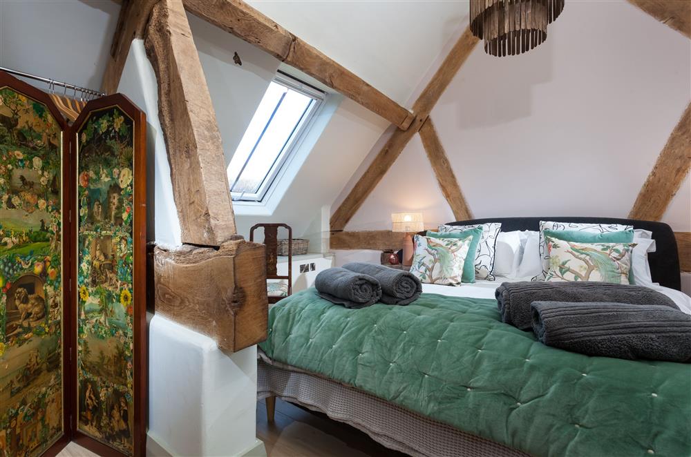Luxurious bedroom two with exposed beams and bathed in natural light at The Cart House, Bridgnorth