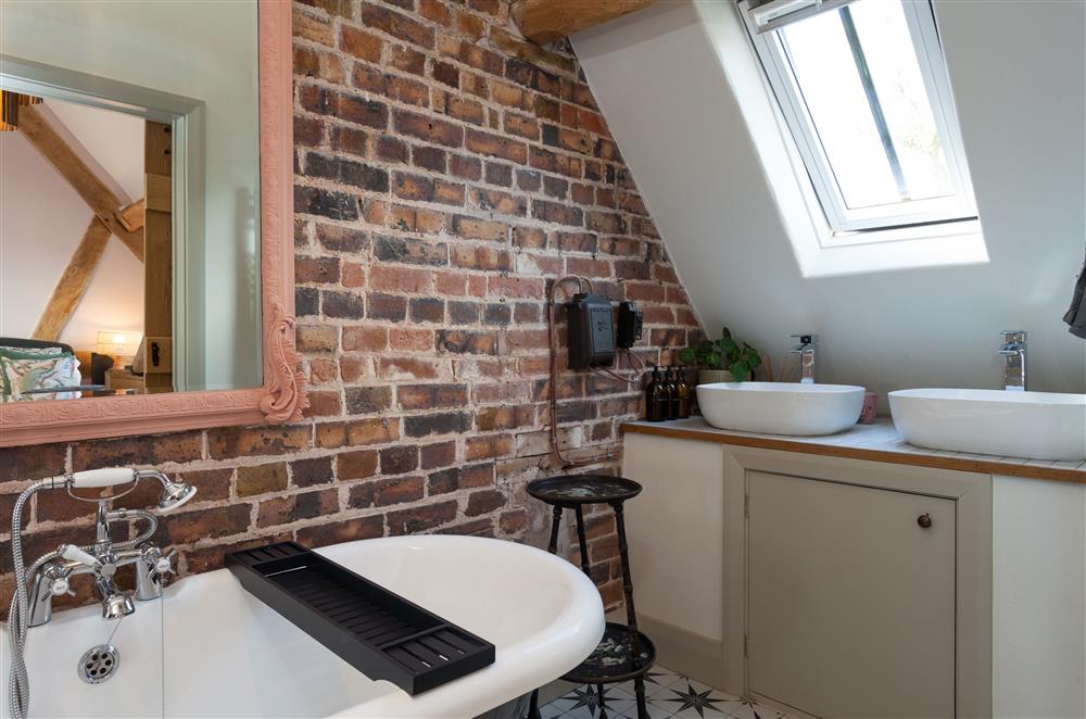 Twin wash basins and exposed stonework in bedroom two’s en-suite bathroom at The Cart House, Bridgnorth