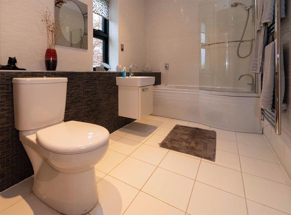 The bathroom boasts a fully tiled shower over Jacuzzi bath at The Cart House in Mauchline, near Ayr, Ayrshire