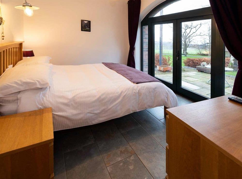 The cosy double bedroom conveniently opens up onto the patio at The Cart House in Mauchline, near Ayr, Ayrshire