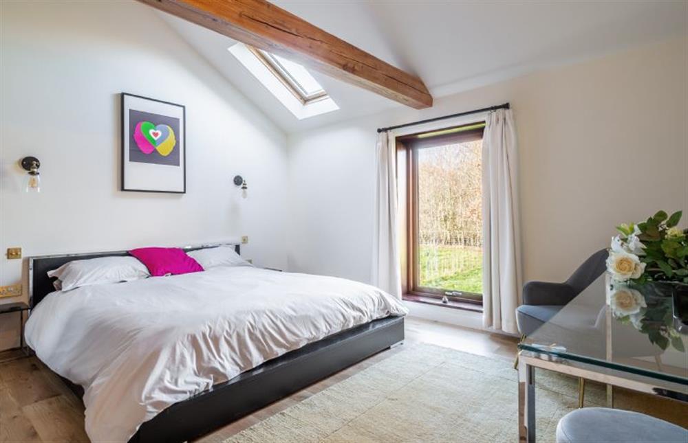 Bedroom one with 6’ super-king size bed at The Cart Lodge, Thornham Magna