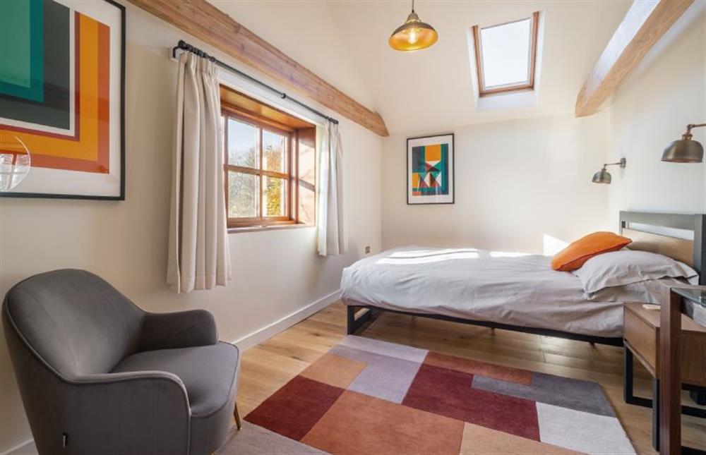 Bedroom two with 5’ king-size bed at The Cart Lodge, Thornham Magna