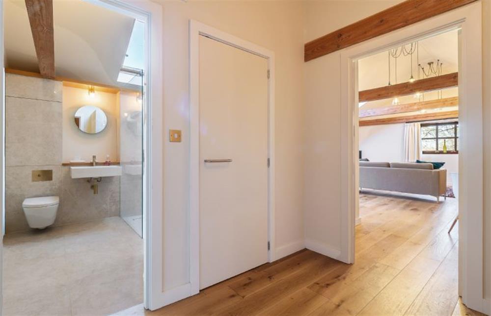 Hallway with views of the shower room and open-plan living space at The Cart Lodge, Thornham Magna