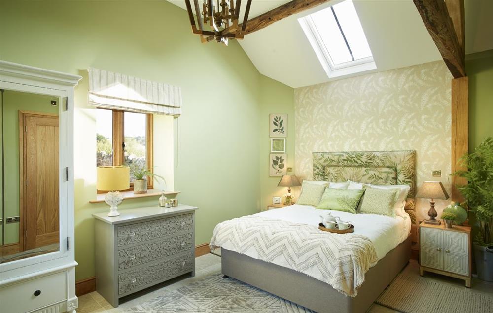 Master bedroom with a king size bed and en-suite bathroom at The Cart Shed, Downton-on-the-Rock