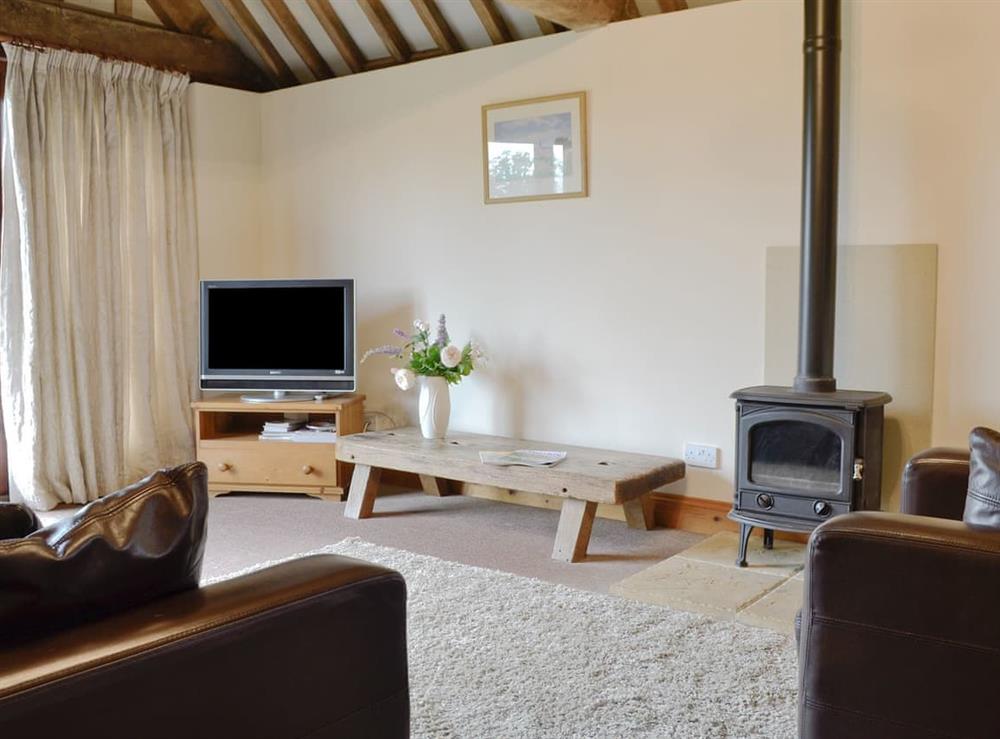 Cosy living area with wood burner at The Carthouse in Malmesbury, Wiltshire