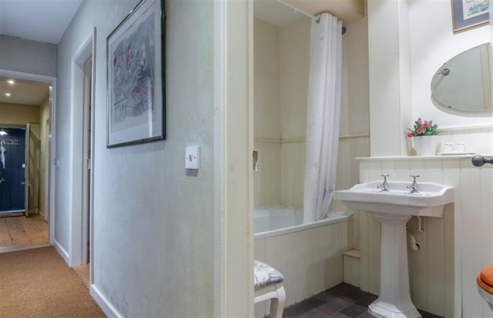 Bathroom with bath and shower over, wash basin and WC at The Cartlodge, Higham