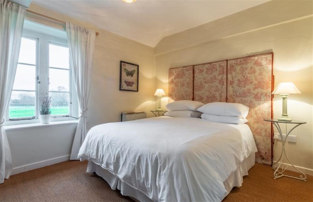 Master bedroom with king-size bed at The Cartlodge, Higham