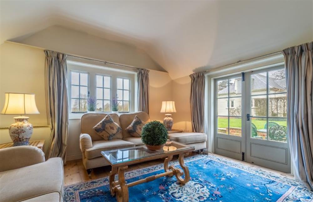 Open-plan living space with french windows onto the terrace at The Cartlodge, Higham