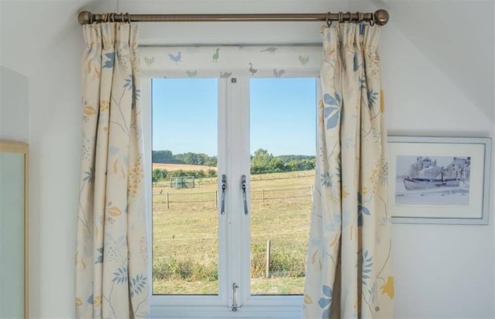 Views from the bedroom over pastureland at The Cartlodge, Iken