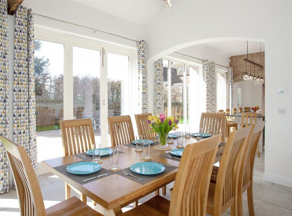 Stylish dining area with views over the garden at The Cartshed in Slindon, near Eccleshall, Staffordshire