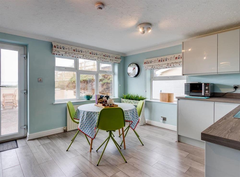 Fully equipped kitchen with dining area at The Castle in Brean, Somerset