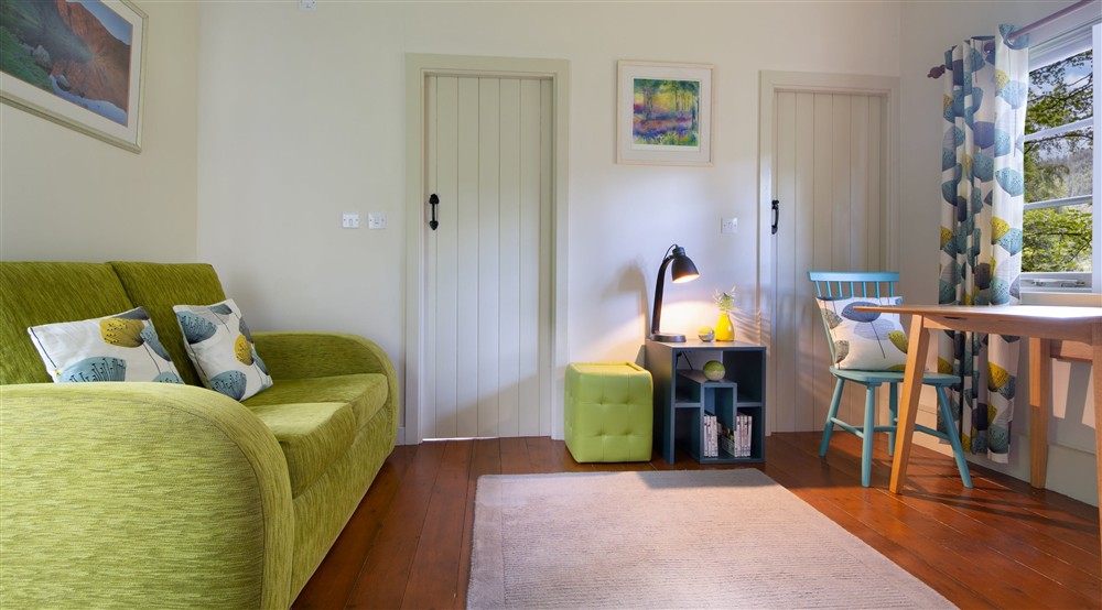 The sitting and dining room at The Chalet At Tan Yr Ogof in Beddgelert, Gwynedd