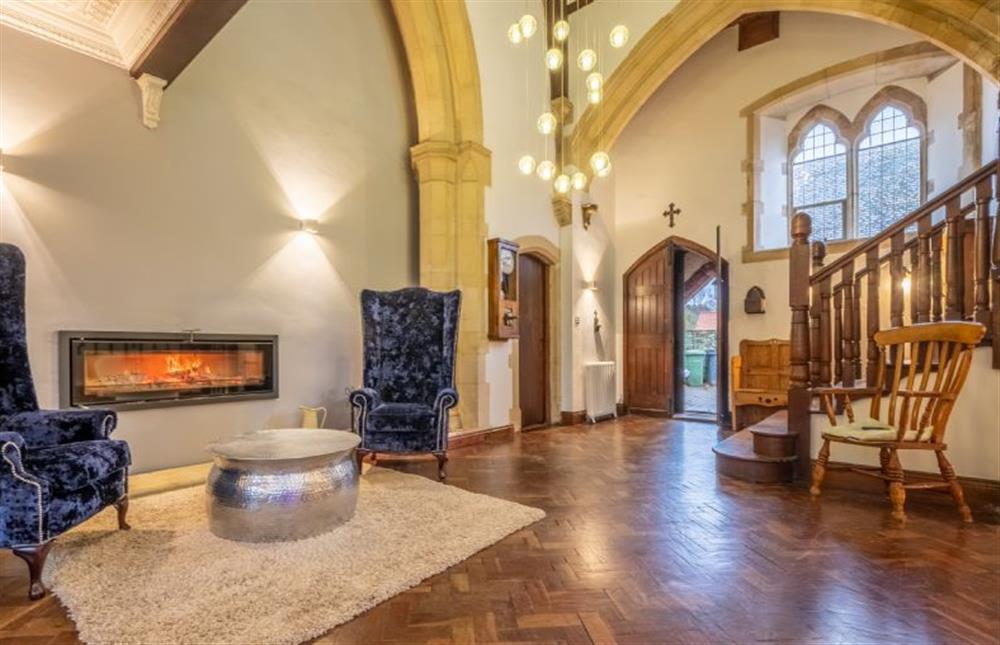 Ground floor: Baronial seating beside the fire at The Chapel, North Elmham near Dereham