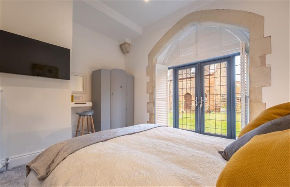 Ground floor: Bedroom three with wall-mounted television at The Chapel, North Elmham near Dereham