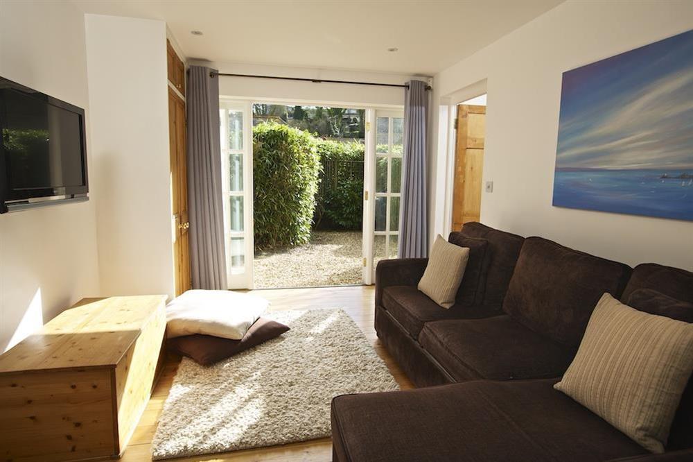 Cosy en suite TV room with L-shaped sofa-bed at The Chota House in Shadycombe Road, Salcombe