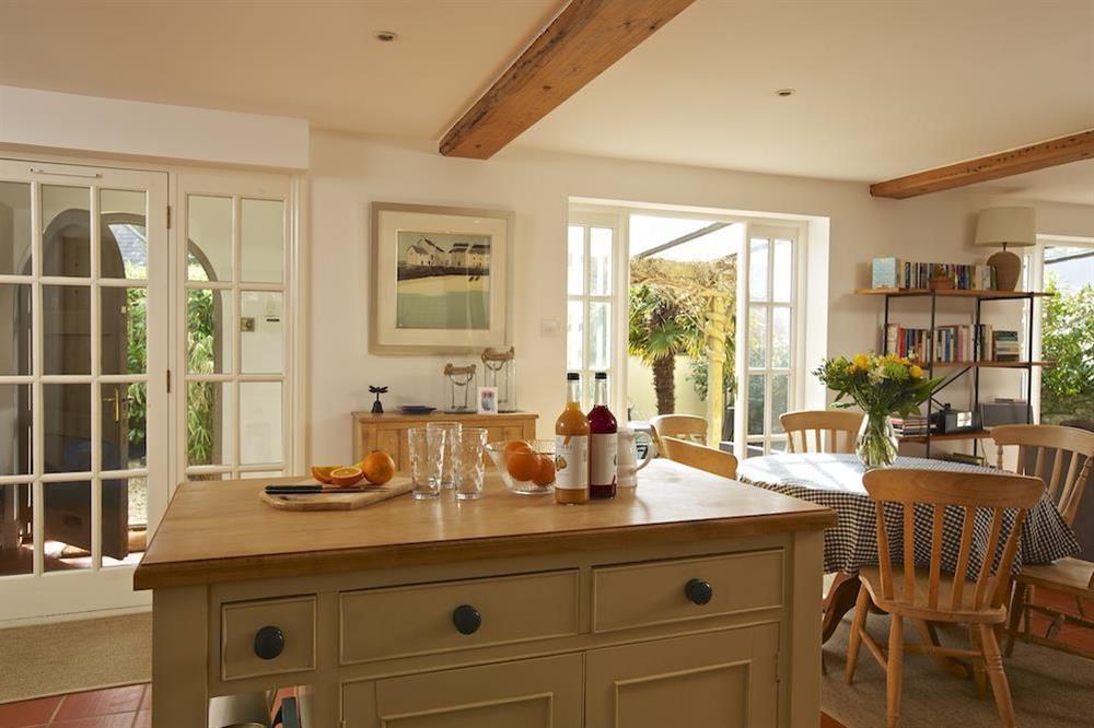 Open plan kitchen and dining area with central island unit at The Chota House in Shadycombe Road, Salcombe