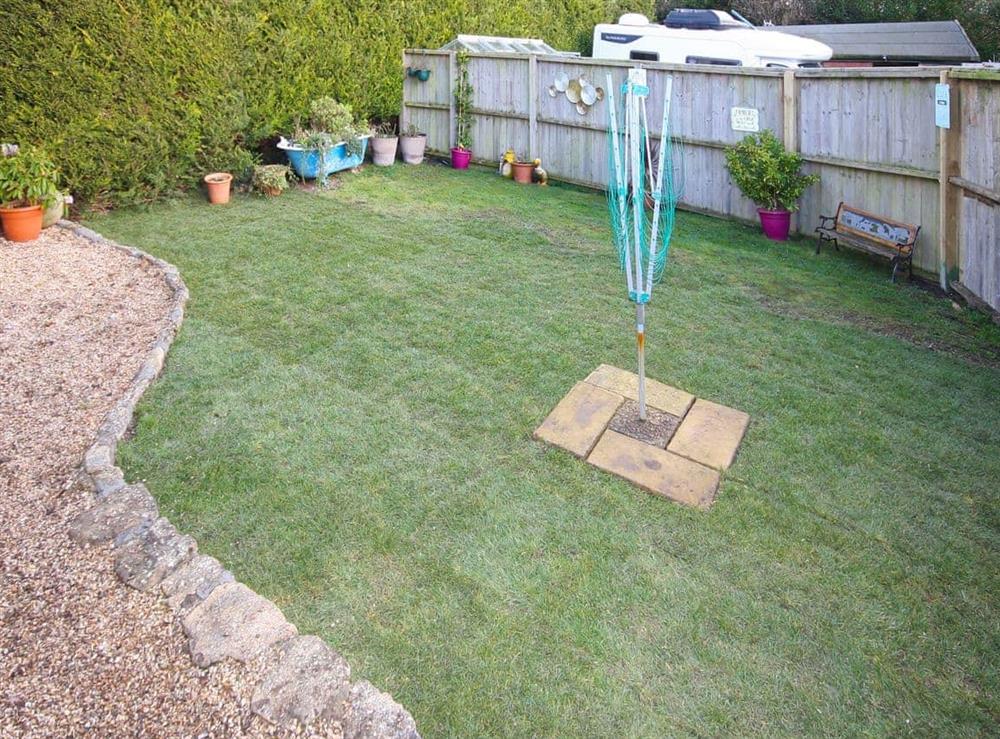 Garden with sitting out area and childrens games at The Cider Press in Watton, near Bridport, Dorset., Great Britain