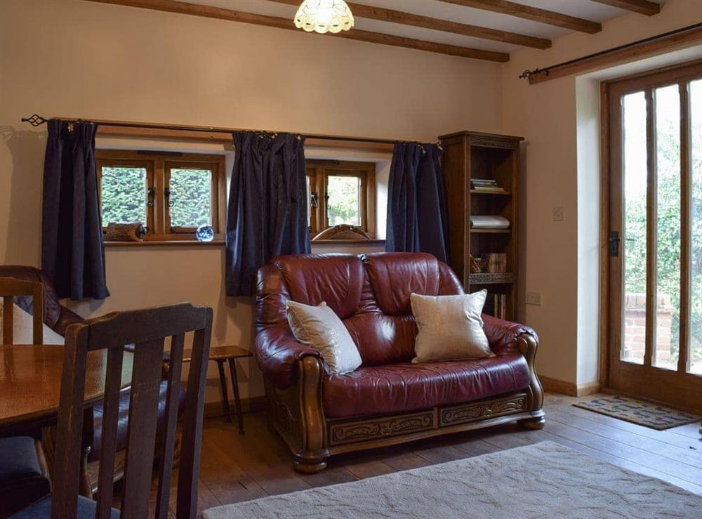 Living room with dining area at The Cider Press in Welland, near Malvern, Worcestershire