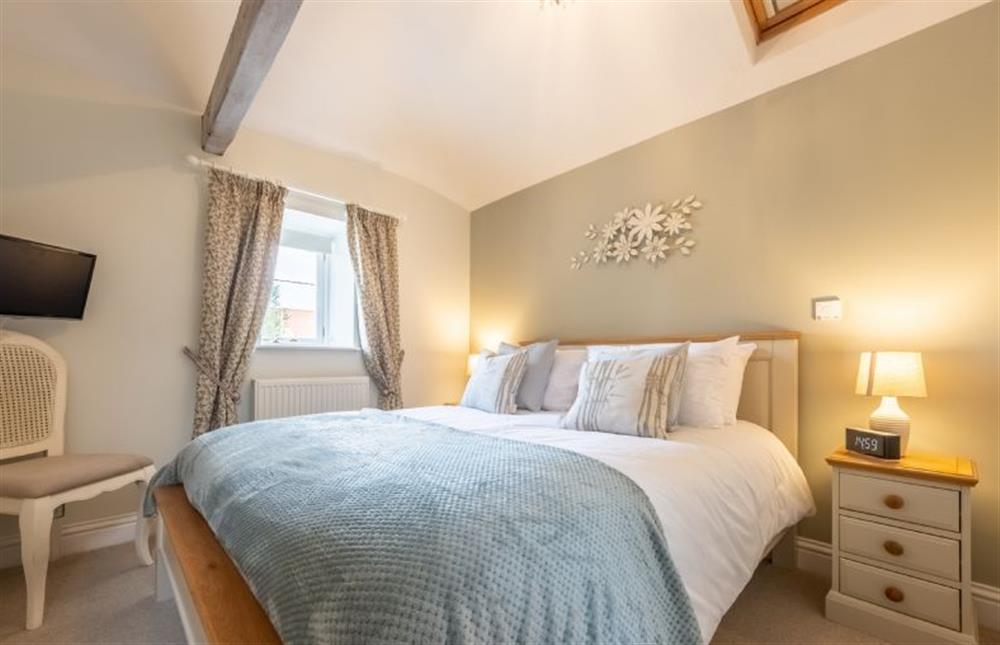 The bedroom on the first floor, with 5’ king-size bed  at The Clockhouse, North Lopham