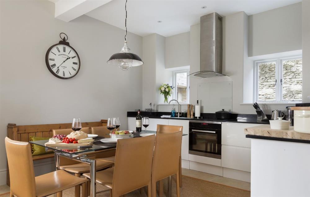 Well-equipped kitchen and dining room seating up to eight guests at The Coach House and Stables at The Lammas, Minchinhampton