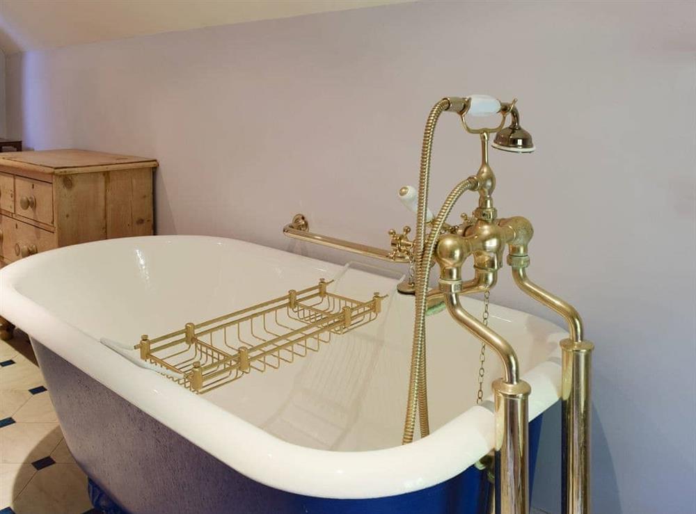 Characterful free-standing bath within the family bathroom at The Coach House in Aston Cantlow, Nr Stratford, Warks., West Midlands