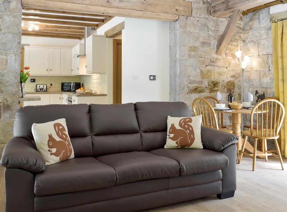 Comfy seating and open-aspect to kitchen at The Coach House at Stable Cottage in Derwydd, near Llandeilo, Carmarthenshire, Dyfed