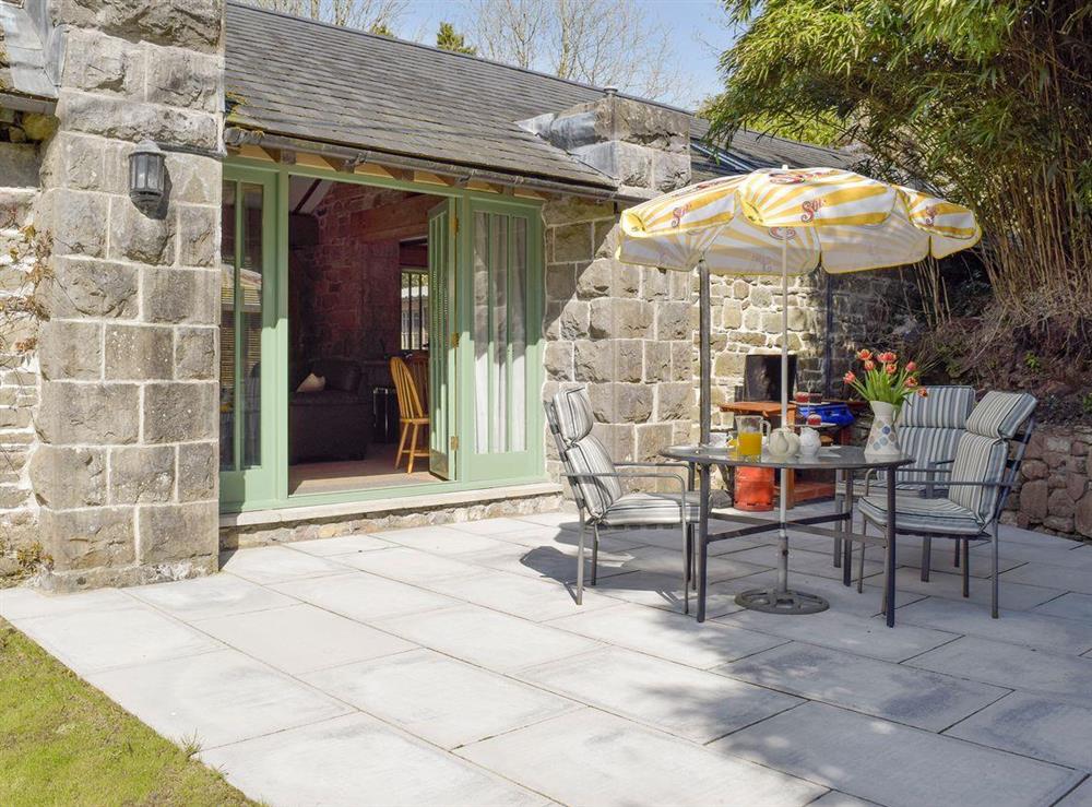 Paved patio with outdoor furniture and BBQ at The Coach House at Stable Cottage in Derwydd, near Llandeilo, Carmarthenshire, Dyfed