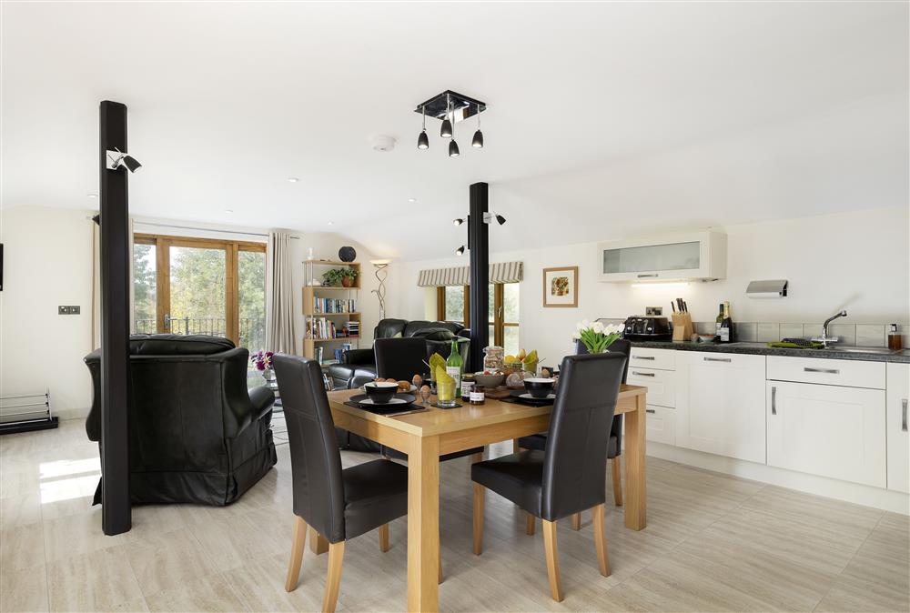 Open-plan living area with dining table seating four at The Coach House at The Old Rectory, Leominster