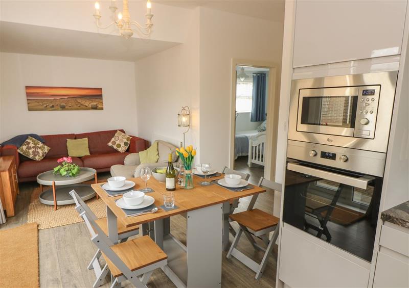 Relax in the living area at The Coach House, Brighstone