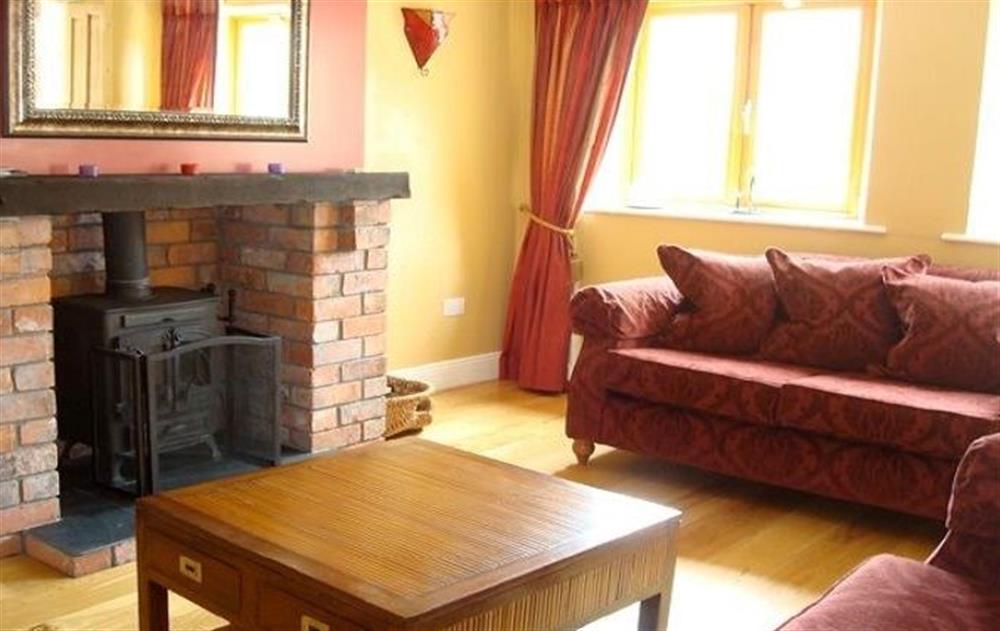 Ground floor:  Spacious sitting room with oak floors and multi-fuel stove