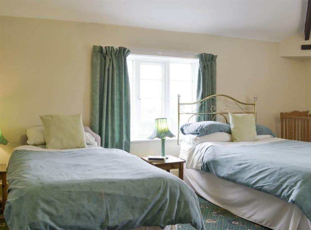 Additional twin bedroom with a double and a single bed at The Coach House in Craven Arms, Shropshire