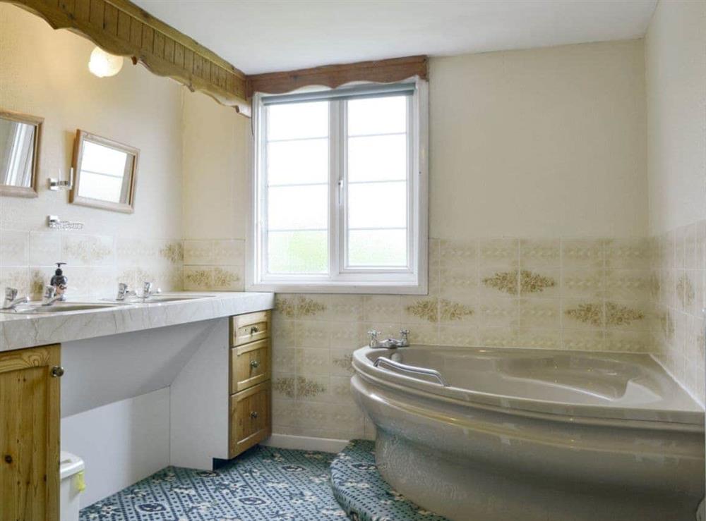 Bathroom with corner bath at The Coach House in Craven Arms, Shropshire