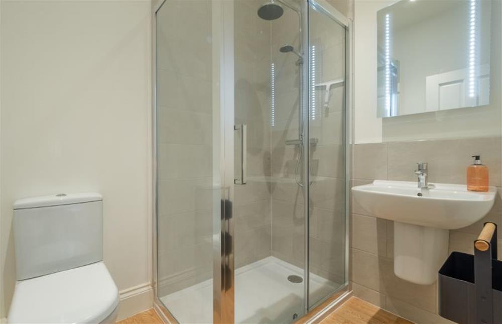 First floor: En-suite with walk-in shower, wash basin and WC at The Coach House, Cromer