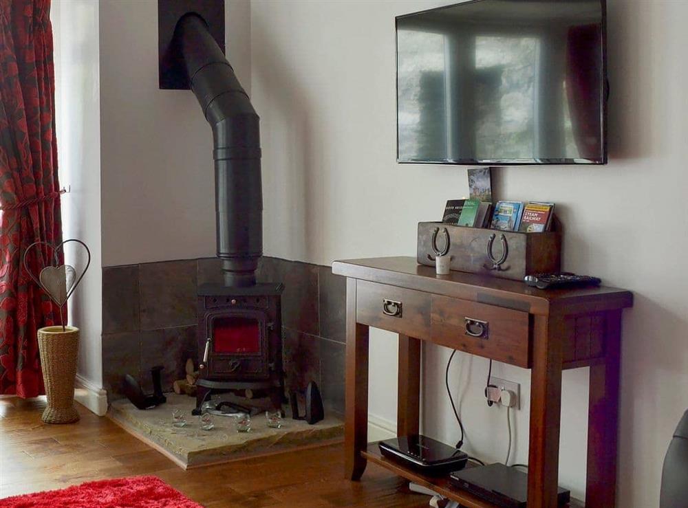 Comfortable  living room with wood burner at The Coach House in Greenodd, near Ulverston, Cumbria