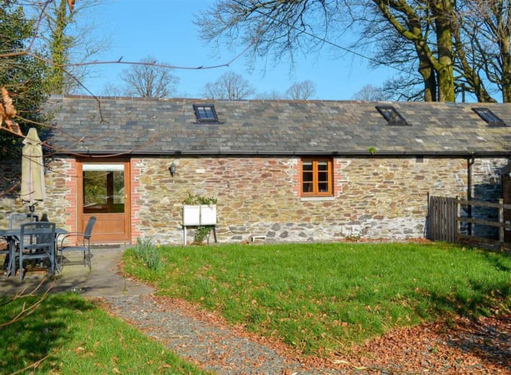 Lawned garden with patio, garden furniture and gas BBQ at The Coach House in Gulworthy, near Tavistock, Devon