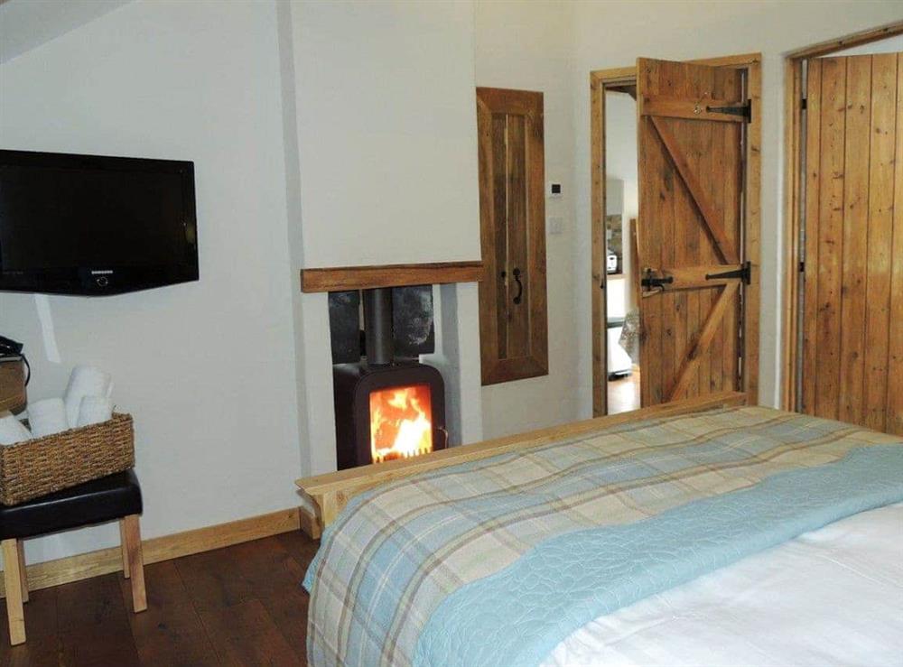 Impressive double bedroom with dual aspect wood burner (photo 2) at The Coach House Loft in Llangrannog, Dyfed