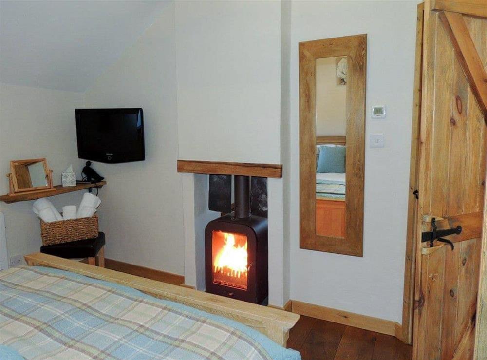 Impressive double bedroom with dual aspect wood burner (photo 3) at The Coach House Loft in Llangrannog, Dyfed