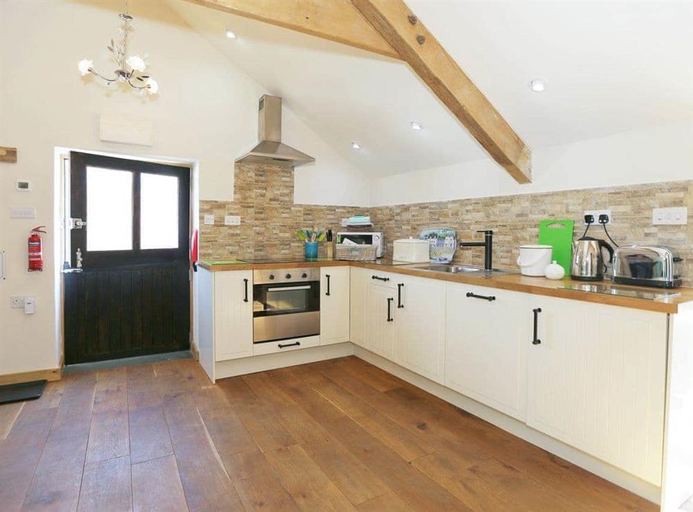 Well-equipped fitted kitchen at The Coach House Loft in Llangrannog, Dyfed