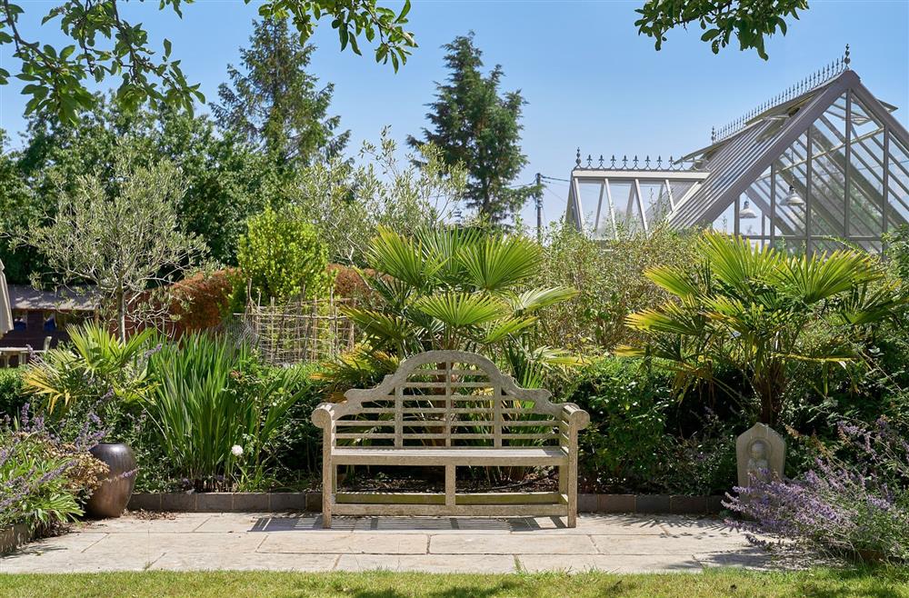 A bench and greenhouse