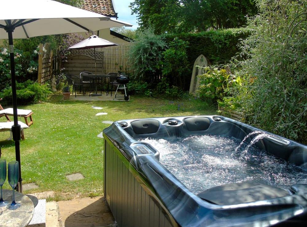 Relaxing hot tub in the garden at The Coach House in Saham Toney, near Watton, Norfolk