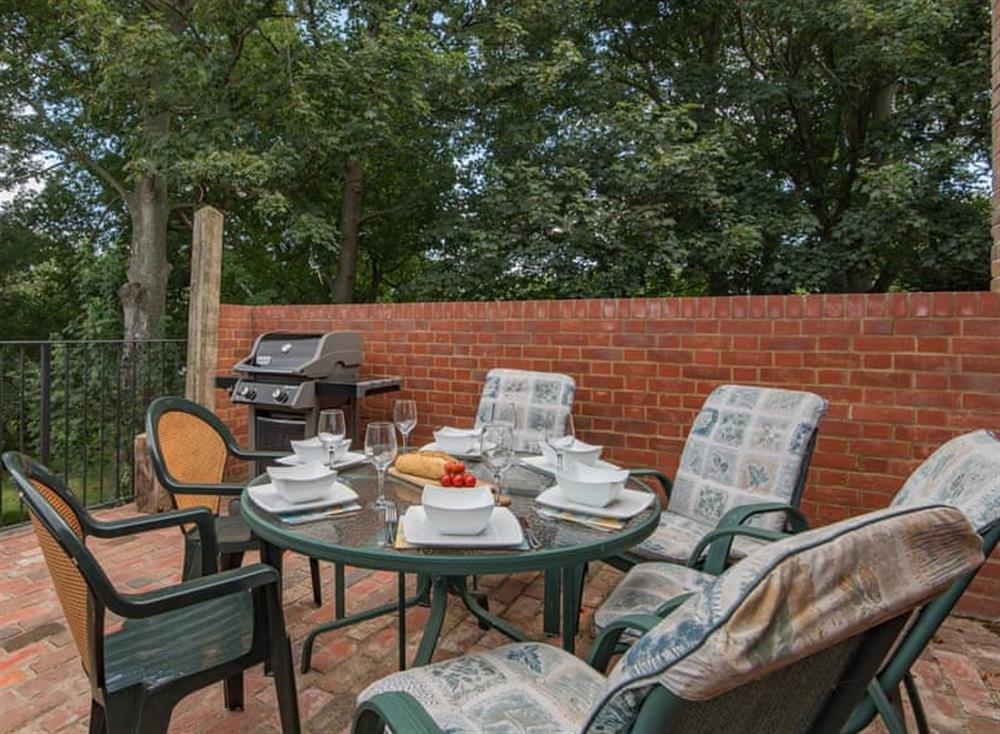 Patio area with outdoor furniture at The Coach House Stables in Hernhill, England