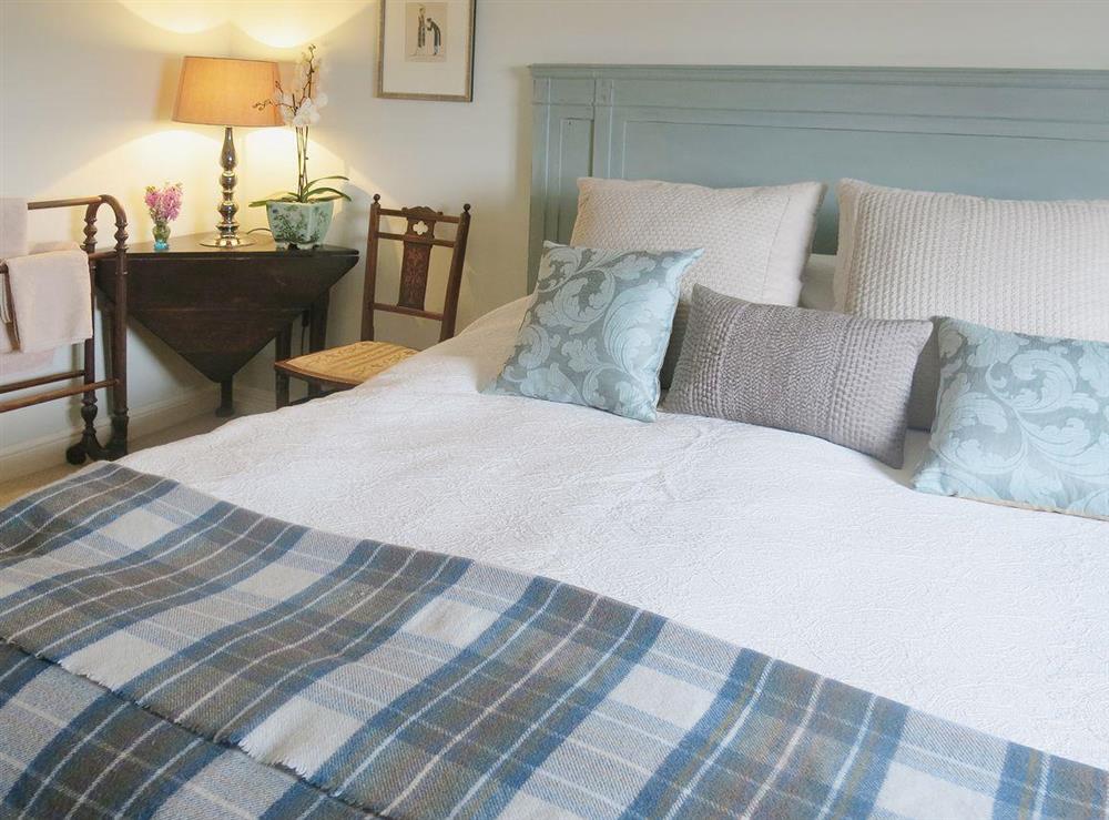 The double bedroom has luxurious bed linen and cosy, romantic furnishings at The Coach House in Tenbury Wells, Worcestershire