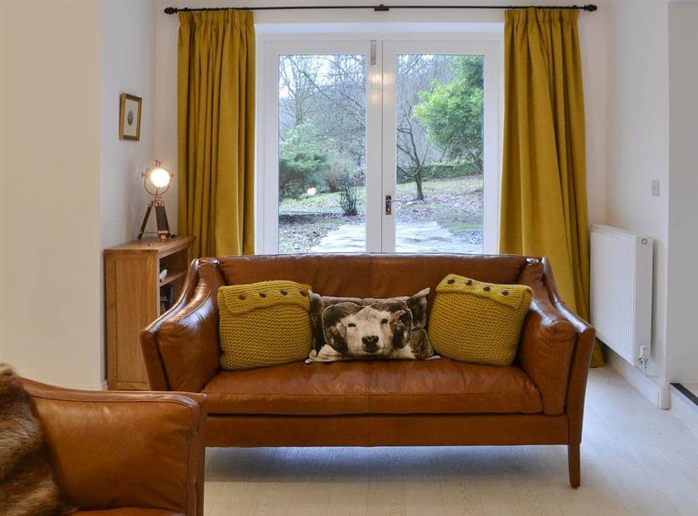 Living area with French doors at The Coach House in White Moss, near Grasmere, Cumbria, England