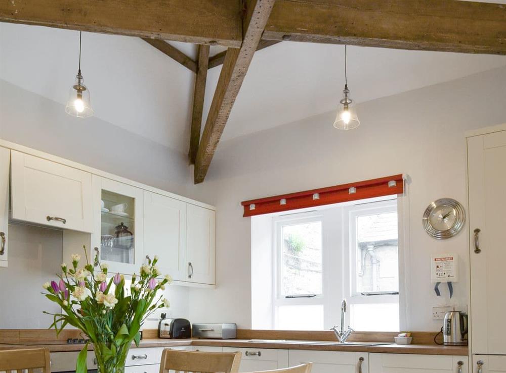 Traditional exposed wood beams in kitchen at The Coach House in Whittingham near Alnwick, Northumberland, England