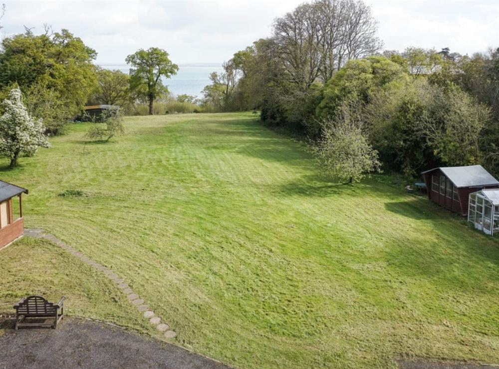 Owners private garden with sea view and access path down to beach at The Coach House in Wootton, near Ryde, Isle of Wight